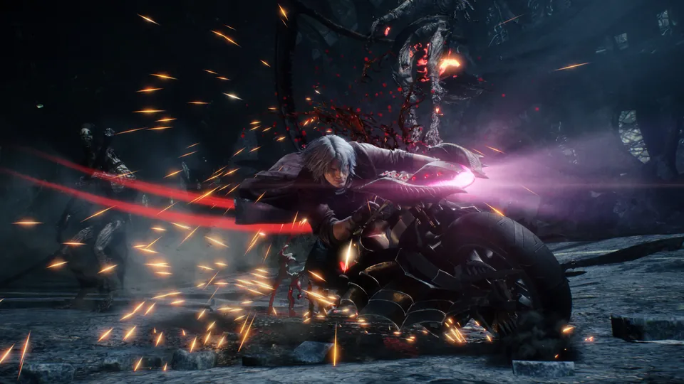 A fighter in a red coat rides a motorcycle through enemies in a shower of sparks in Devil May Cry 5