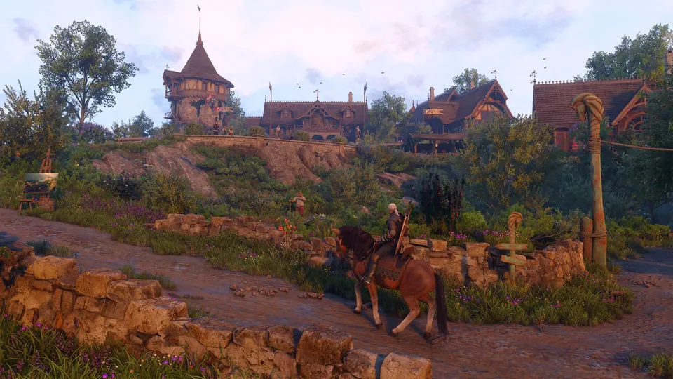 Geralt rides a horse along a stone wall below a hillside village with a turreted house in Letten
