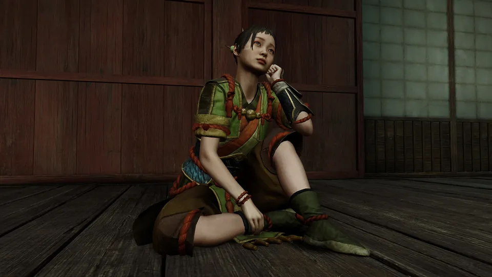 Okuni sits on a wooden floor in the free Yomogi's Dance outfit from Monster Hunter Rise in Onimusha: Way of the Sword