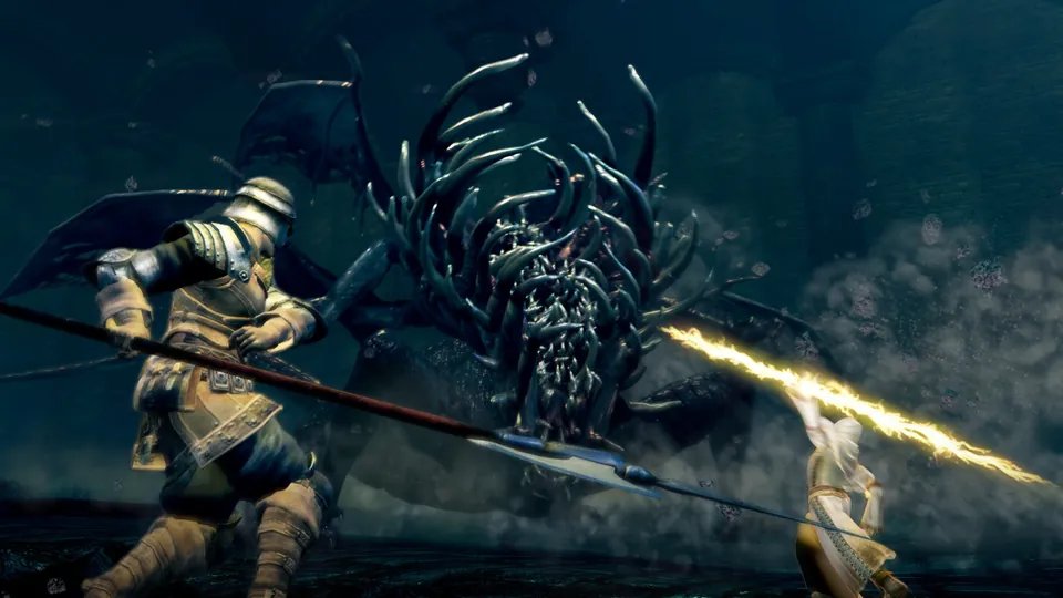 A knight with a spear fights a giant dark creature beside a glowing ally in Dark Souls Remastered