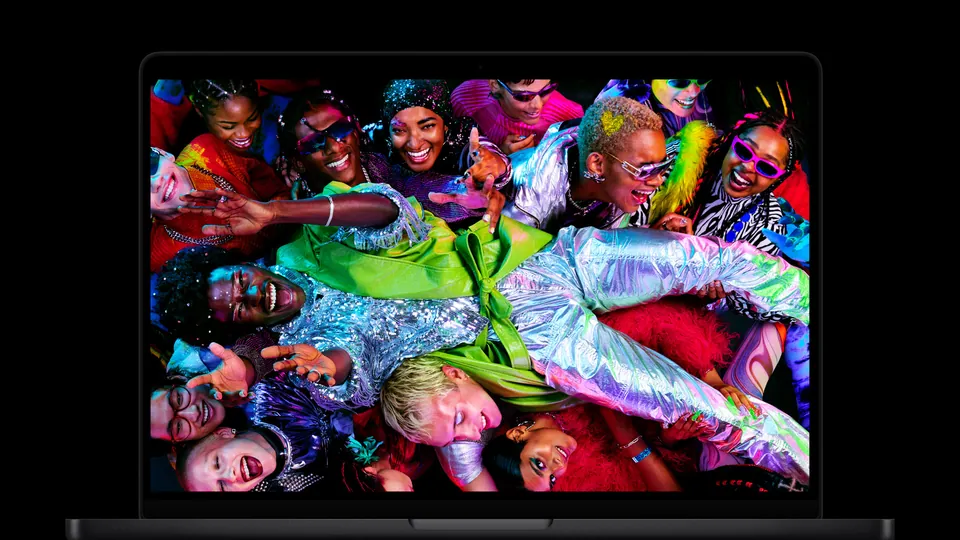 The current MacBook Pro with M5 Pro and M5 Max, open, with a bright photo on its mini-LED Liquid Retina XDR display