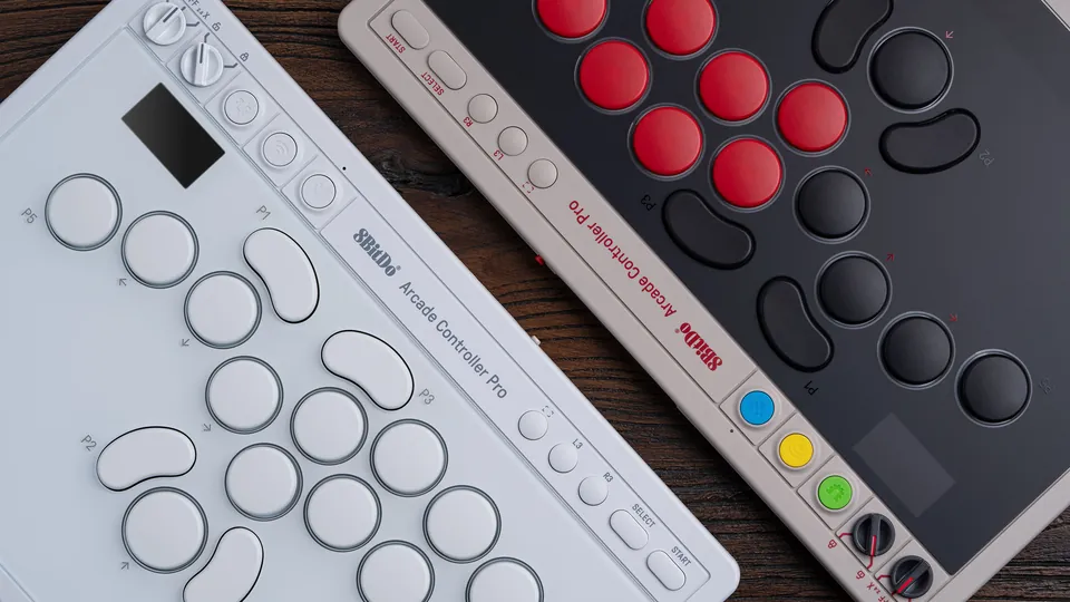 White Edition of the 8BitDo Arcade Controller Pro lying next to the gray N Edition with red and black buttons