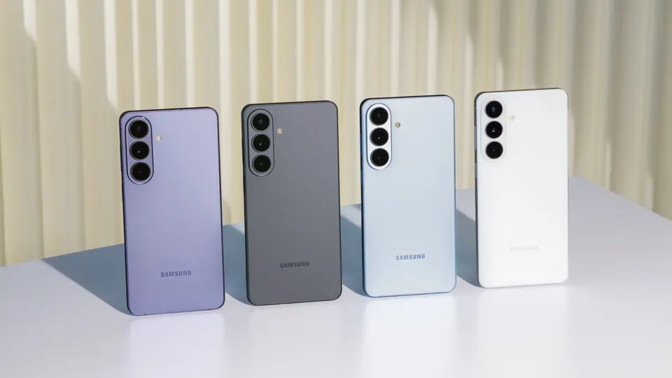 Four Galaxy S26 phones in different colors in front of a pleated curtain