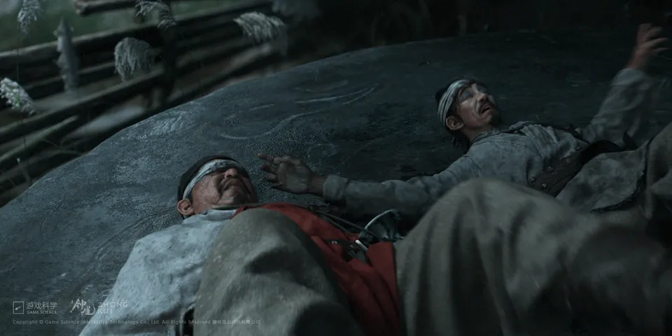 Two wounded men in headbands lie on a large rock in the Black Myth: Zhong Kui teaser