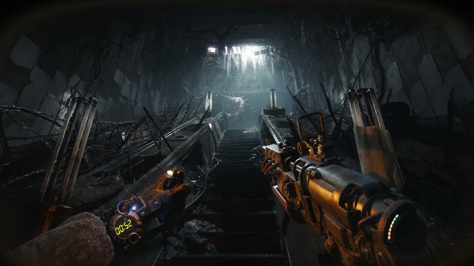 A first-person view down a dark tunnel stairway with a weapon raised in Metro 2039