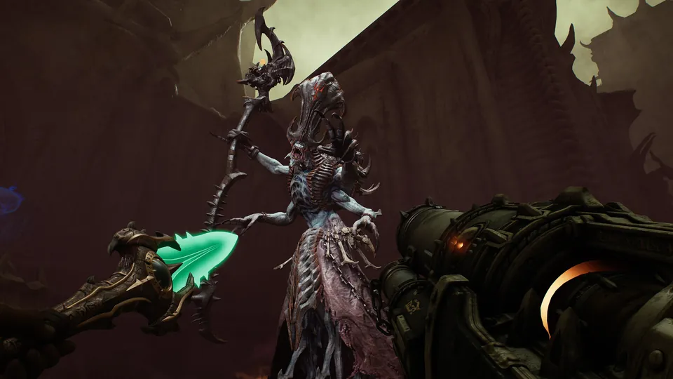 A pale, horned demon holding a jagged staff stands beyond the glowing green tip of the Chain Spear in Doom: The Dark Ages Revelations