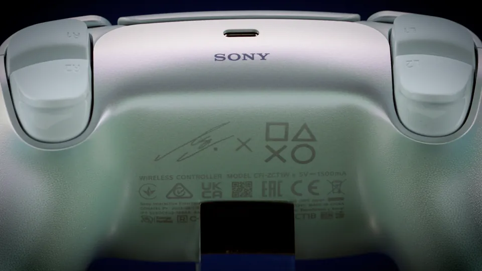 The back of the DualSense LISA Limited Edition, with LISA's signature and the PlayStation shapes under the Sony logo