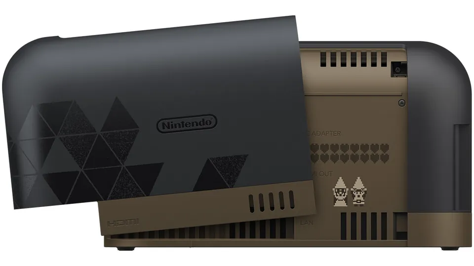 The Zelda edition Switch 2 dock with its back cover lifted, showing pixel-art characters and a row of hearts inside.