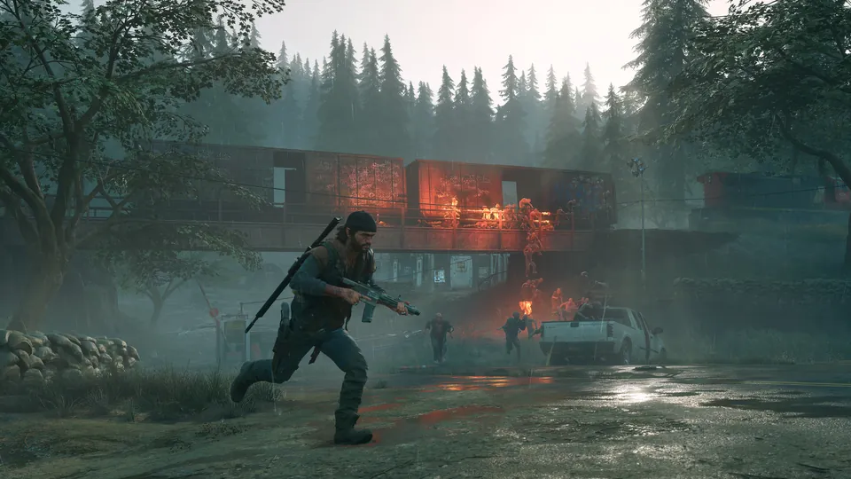 Deacon St. John runs with a rifle past a burning train car in the rain in Days Gone