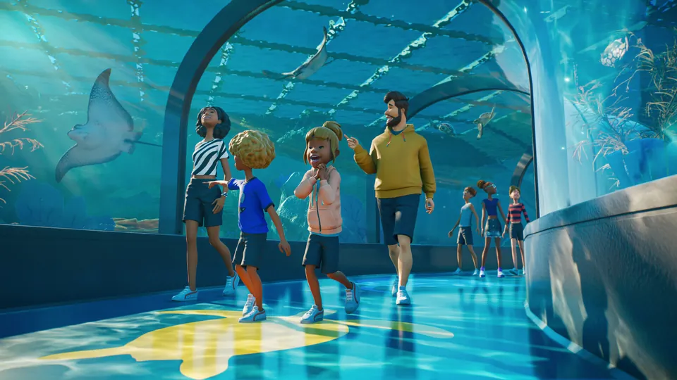 Zoo guests walking through an underwater tunnel as a manta ray glides overhead