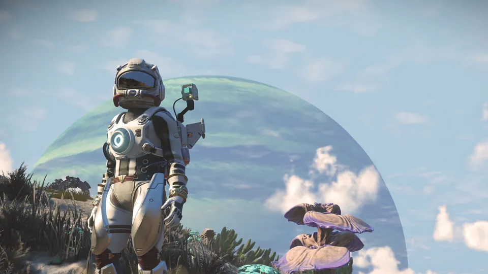 An explorer in a white spacesuit stands among alien plants in front of a giant planet in No Man's Sky