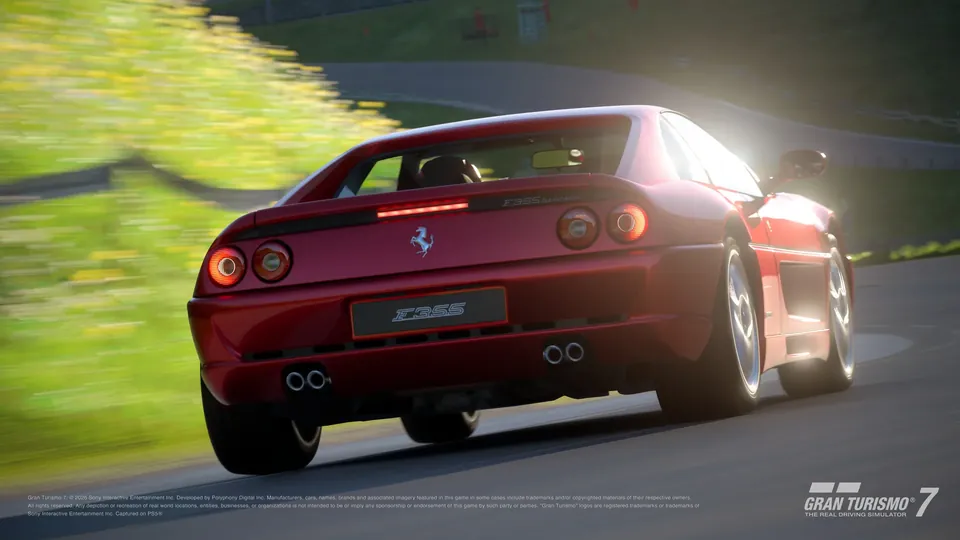 A red Ferrari F355 Berlinetta from 1994 driving away on a sunlit track in Gran Turismo 7