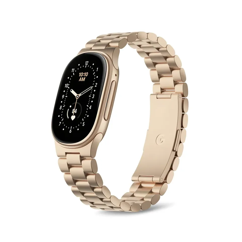 A gold Fitbit Edge on a gold Metal Links band with an analog watch face