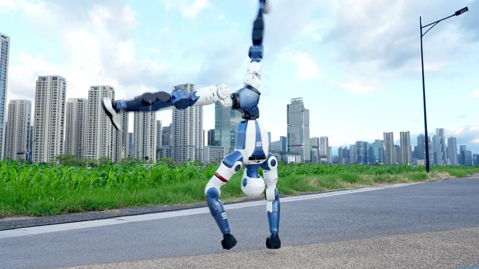 A Unitree R1 does a handstand on a city sidewalk with tall buildings behind