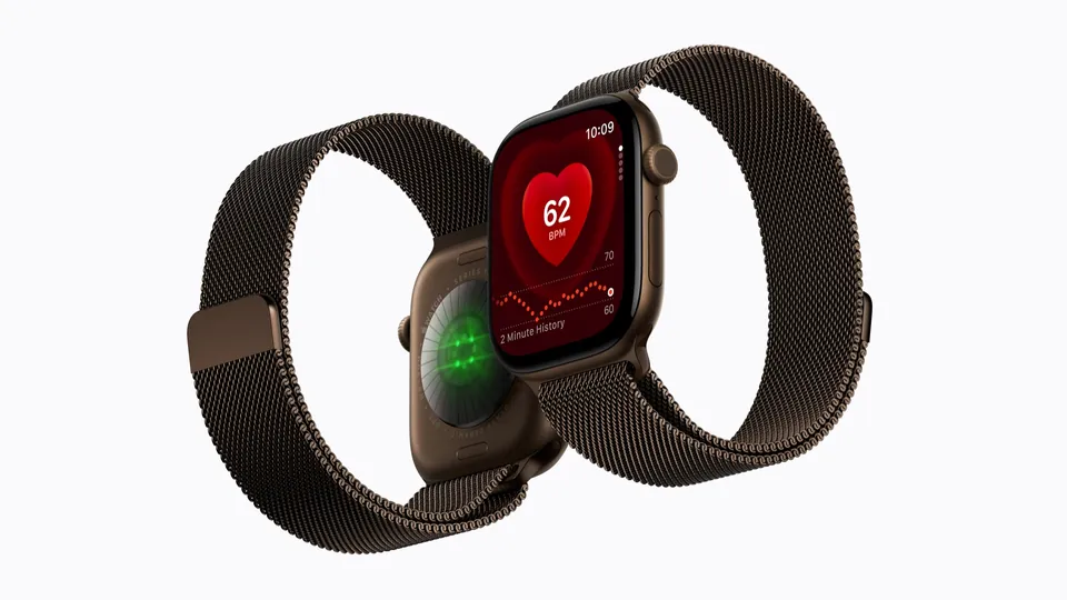 Two Apple Watch Series 12 models on a Milanese Loop, one showing the sensors on its back and one the Heart Rate app