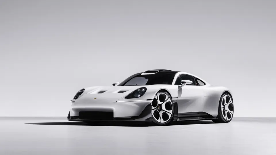 The white Porsche Mission S vision model from the front three-quarter view, with round headlights and dial-style wheels