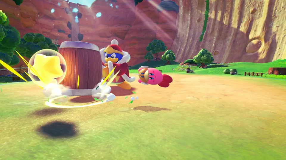 King Dedede slams a huge wooden hammer as Kirby dives clear on a grassy canyon floor in Kirby and the World Beyond.