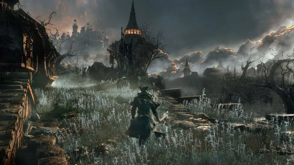 A hunter in a long coat and hat walks through tall grass toward the spires of Yharnam under a stormy sky in Bloodborne