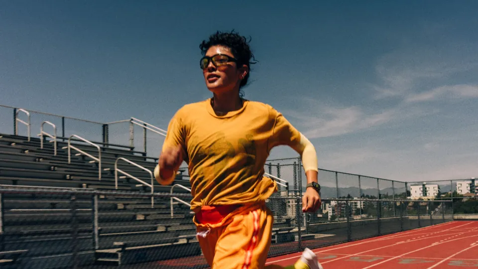 A runner wearing Apple Watch Series 12 sprints on a track
