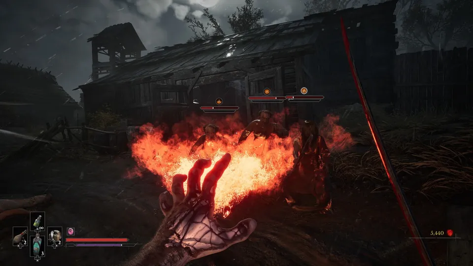 A burning hand casts a fire spell in front of a ruined wooden building in Valor Mortis